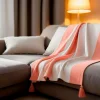 Couverture plaid 100% coton rose saumon avec pompons 130x170cm SLAVANN - SACASA